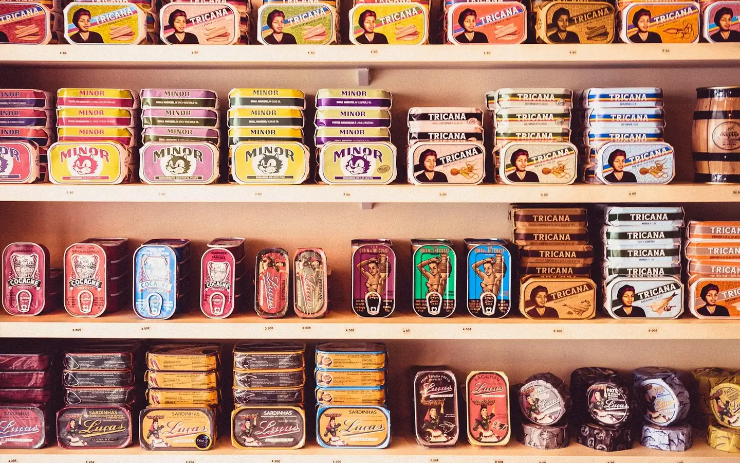 Shelves stacked with rows of brightly coloured tinned fish packs